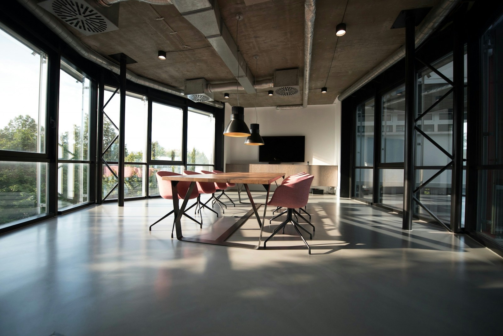 Open commercial workspace with meeting areas and natural light